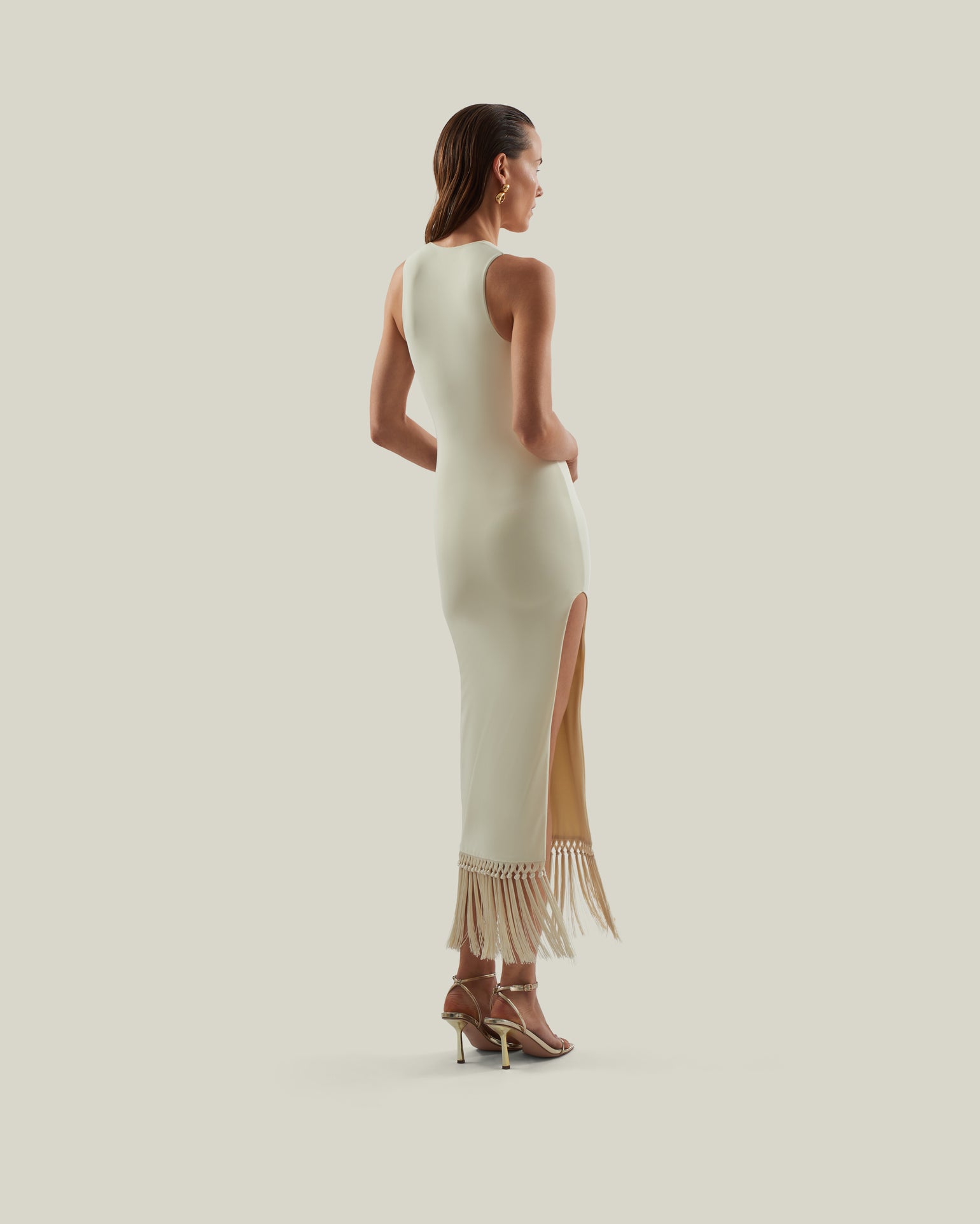 Sahara Dress in Ivory - Laced-up plunge neckline dress with hand-tied fringed hem and side slit