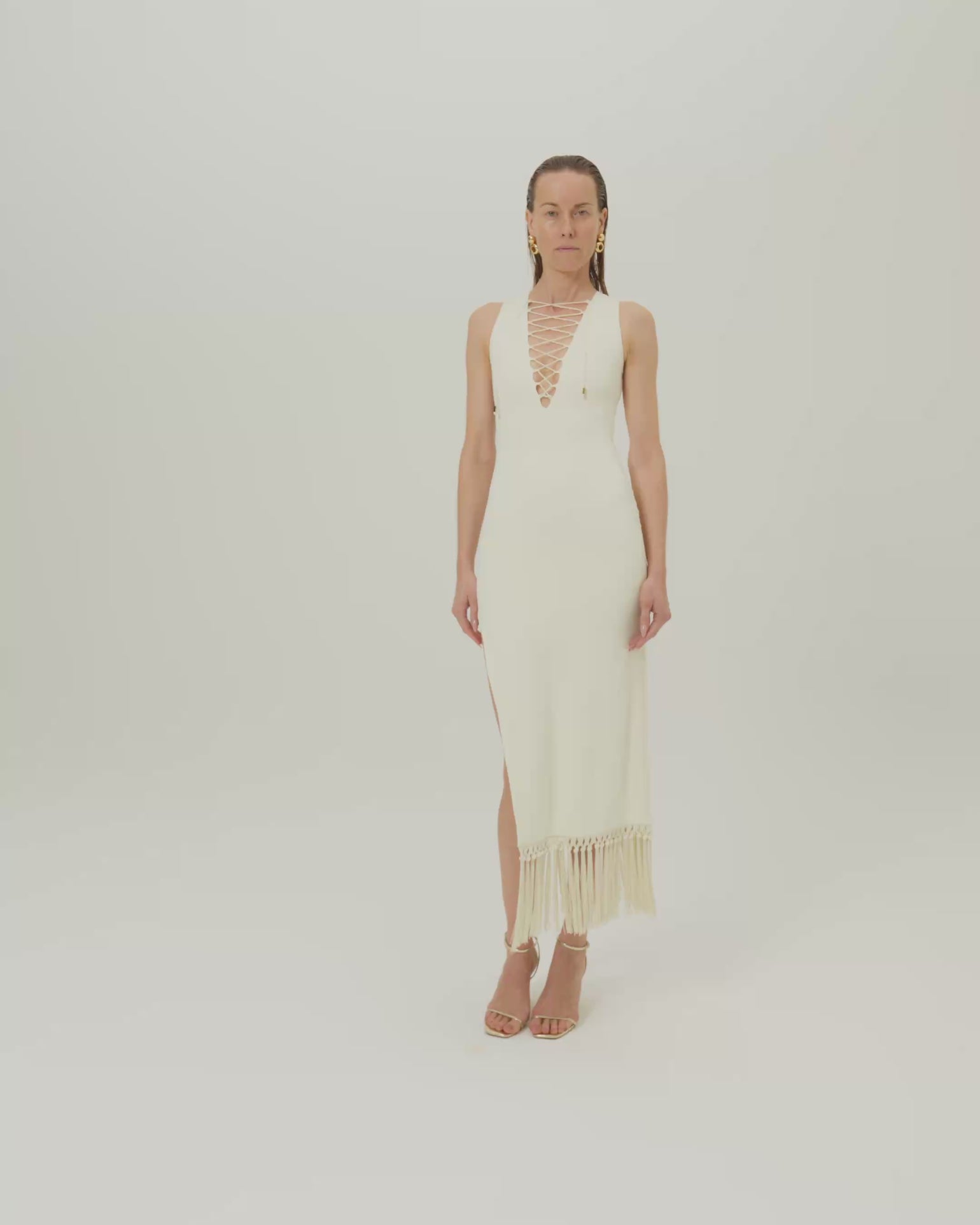 Sahara Dress in Ivory - Laced-up plunge neckline dress with hand-tied fringed hem and side slit